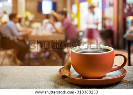 cup of espresso with blur people in coffee shop background