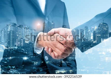 Double exposure of handshake and city night, blue tone
