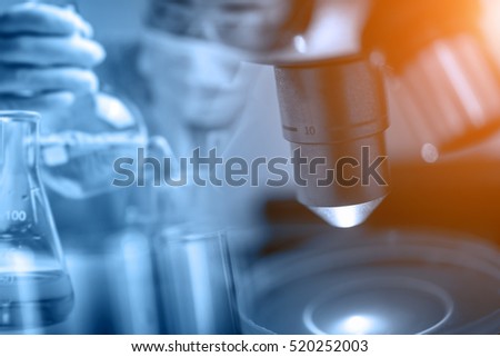 Microscope with blur scientist in laboratory background, science research and development concept