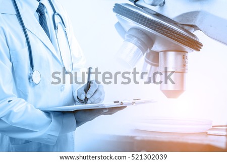 Doctor with microscope, medical research and development concept