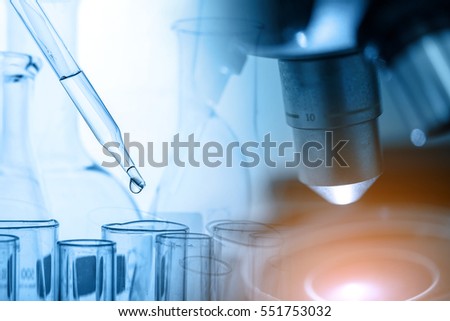 microscope with lab glassware, science laboratory research and development concept