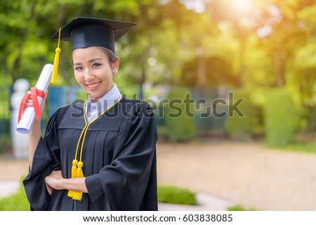 Graduated woman students wearing graduation hat and gown