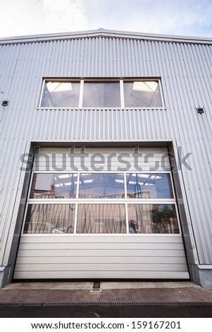 Sliding door of a white industrial hall