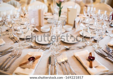 Romantic wedding table arrangement with beige tablecloth and napkins