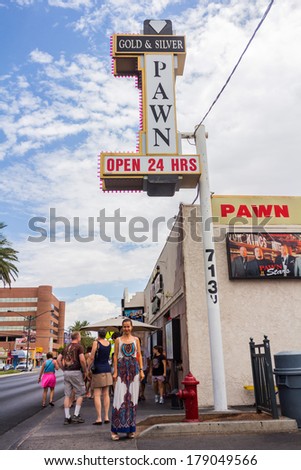 LAS VEGAS - JULY 14,  2013: Tourists in front of famous Gold and Silver Pawn Shop.