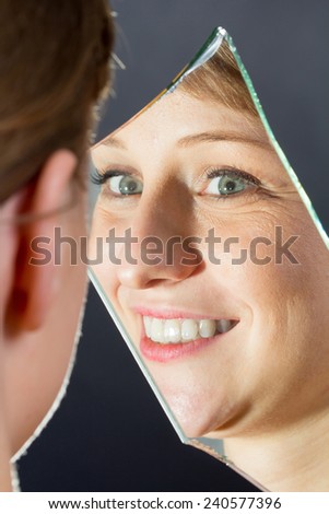 Reflection of a blonde girl in the mirror