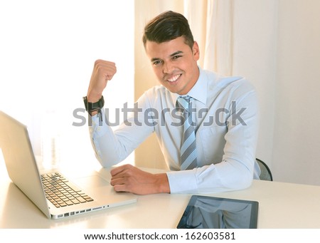 Young Successful Happy Man working at the office with Computer and Tablet