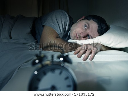 Young Man In Bed With Eyes Opened Suffering Insomnia And Sleep Disorder Thinking About His Problem