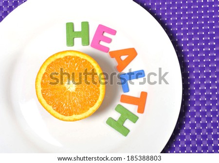 Halved fresh and healthy Orange Fruit stillife on plate health concept