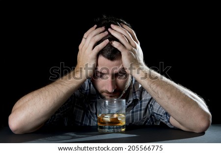 close up portrait of alcoholic wasted man sleeping drunk looking at whiskey glass avoiding temptation thinking of alcohol addiction , drinking abuse , alcoholism concept isolated on black background
