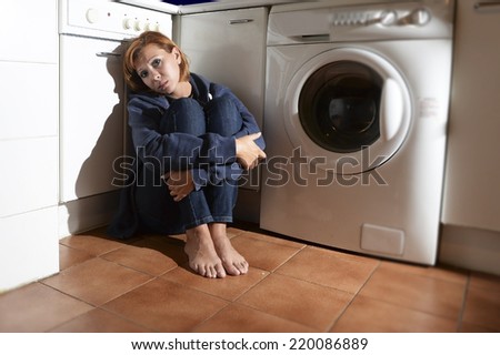 lonely depressed and sick woman sitting alone on kitchen floor in stress , depression and sadness feeling miserable in barefoot looking desperate