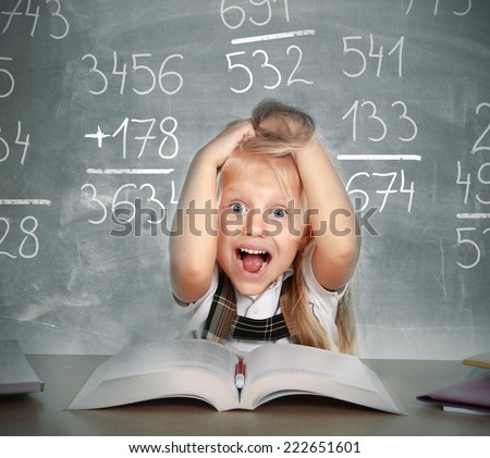 sweet little school girl pulling her blonde hair in stress getting crazy with maths calculation studying doing homework in children education concept on blackboard full of numbers