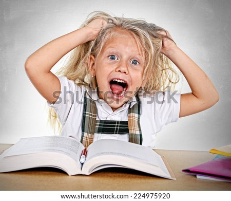 sweet little school girl pulling her blonde hair in stress getting crazy while studying and  doing homework in children education concept isolated on white background