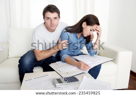 young couple worried home in stress husband comforting wife accounting debt bills bank papers expenses and payments feeling desperate in bad financial situation