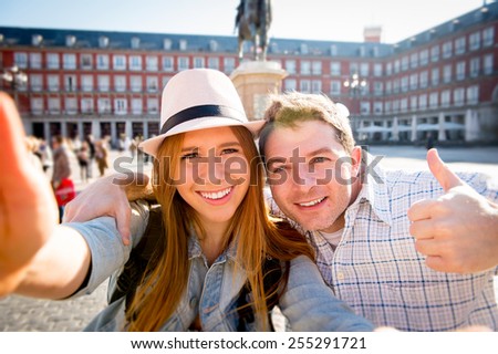 young beautiful friends tourist couple visiting Europe in holidays exchange students and taking selfie picture together in town smiling happy on sunny day in travel and vacation concept