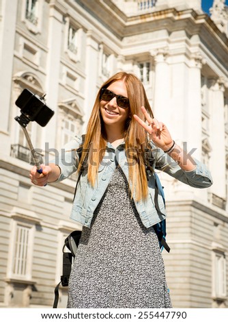 young beautiful tourist woman visiting Europe on holidays exchange students and taking selfie picture  in town happy on sunny day in travel and vacation concept