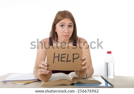 young beautiful college student girl studying for university exam in stress asking for help under test pressure sitting on desk with book in youth education concept