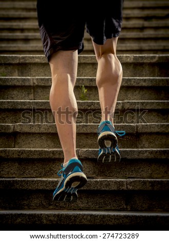 athletic legs of young sport man with sharp scarf muscles running on staircase steps jogging in urban training workout or runner competition in fitness and healthy lifestyle concept
