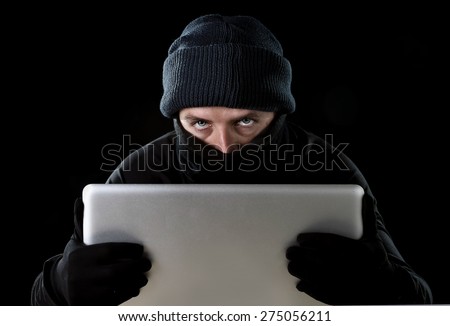 hacker man in black using computer laptop for criminal activity hacking password and private information cracking password too access bank account data in cyber crime concept