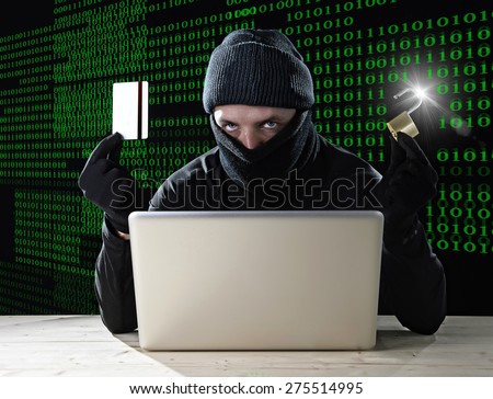 man in black holding credit card and lock using computer laptop for criminal activity hacking bank account password and private information cracking password for illegal access in cyber crime concept