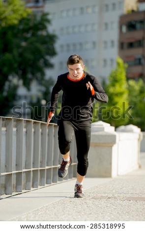 young athletic man practicing running sprinting on urban city park background in summer sport training session, body and health care and healthy lifestyle concept