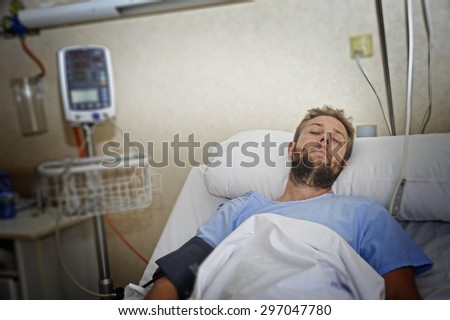 young injured man lying in bed hospital room resting from pain looking in bad health condition after suffering accident in health care concept