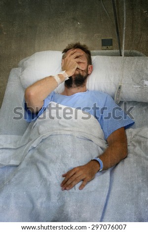 young injured man lying in bed hospital room resting from pain worried about  bad health condition after suffering accident looking pensive sad and depressed in health care concept