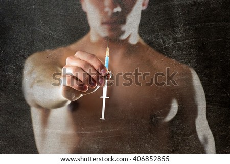 young body building sportsman using steroids for increasing sport and athletic  performance holding syringe isolated on back background in sport cheat doping and illegal use of hormones