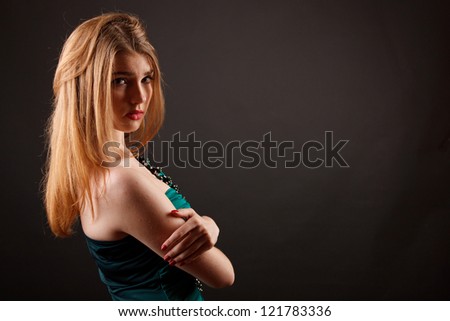 Studio portrait of a beautiful young woman in green dress
