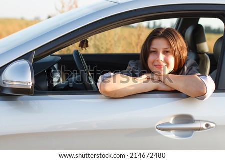 A happy driver leaning out of the window