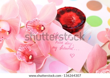 cake with strawberry souffle and a bouquet of flowers. a beautiful gift for the woman of the man she loved. delicious, sweet breakfast