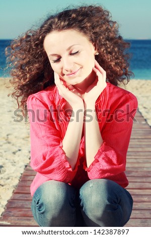 Fashion outdoor portrait of young girl in a summer style by the sea