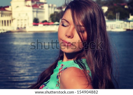 Outdoor fashion closeup portrait of young pretty woman in autumn sunny day on street