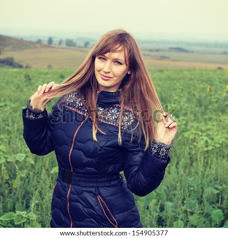Happy woman enjoying nature. Autumn fashion portrait outdoors