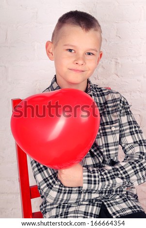Boy with a heart shaped balloon