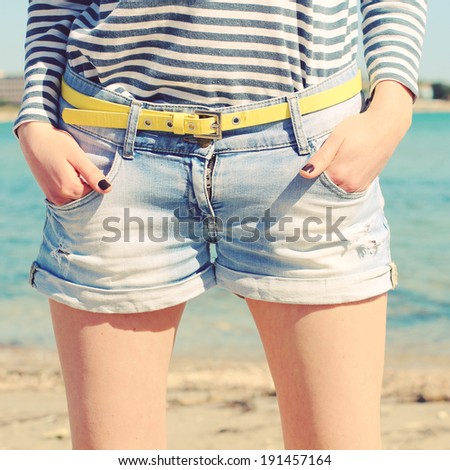 Stylish denim shorts. Youth summer fashion. Photo toned style instagram filters