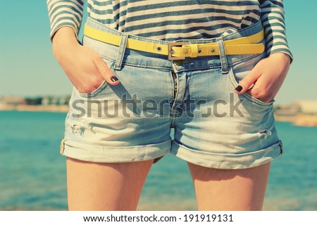 Stylish denim shorts. Youth summer fashion. Photo toned style instagram filters