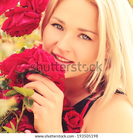 Portrait of beautiful fashionable woman in the bush of purple roses. Luxury woman. Vogue style. Outdoor in summer sun light. Photo toned style instagram filters