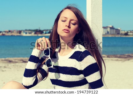 Fashionable girl photo. Marine style. Woman at the beach. Summer vacations concept. Photo toned style instagram filters
