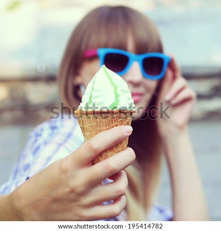 Woman eating a delicious pistachio ice cream. Photo toned style Instagram filters