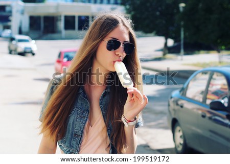 Young beautiful woman eating a dessert. Photo toned style Instagram filters