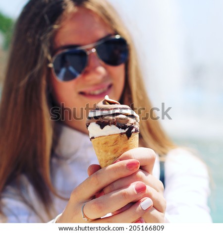 Woman eating a chocolate ice cream. Photo toned style Instagram filters
