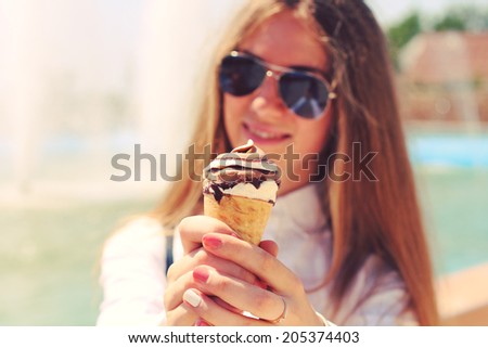 Woman eating ice cream. Photo toned style Instagram filters