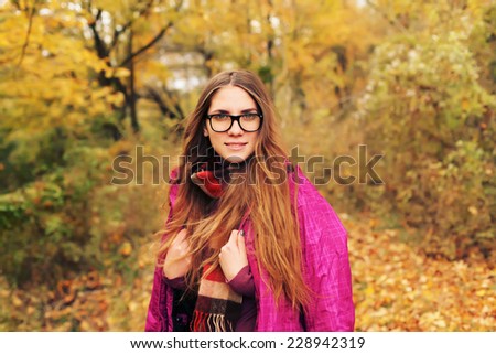 Close up portrait of beautiful hipster woman with long hairs, wearing stylish youth clothes. Autumn retro style.