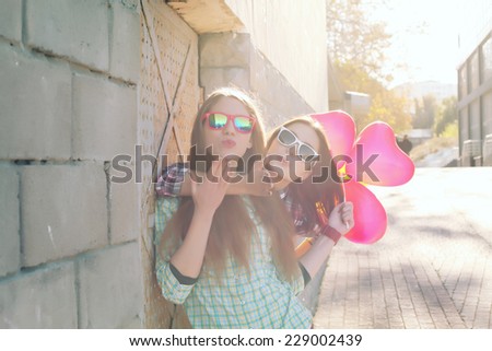 Young pretty hipster girls friends having fun outdoor in summer on the street Vintage lifestyle trendy portrait Photo toned style Instagram filters Young pretty hipster girls friends having fun outdoor in summer on the street Vintage lifestyle trendy portrait Photo toned style Instagram filters