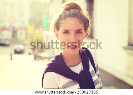 Beautiful happy hipster girl goes shopping in the city. Closeup of trendy girl face. Photo toned style instagram filters