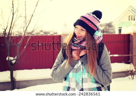 Portrait of Trendy Hipster Girl on Bright Winter Clothes, Traveler Woman with Backpacks. Freedom and Active Lifestyle Concept Photography Toned Style Instagram Filters.