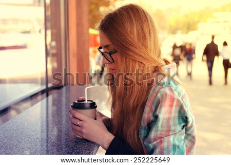 vintage color tone style of beauty girl with cup of coffee. drinking coffee walking in street wearing fashion youth clothes