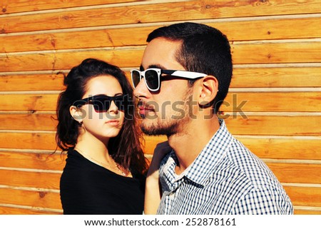 Holidays, vacation, love and friendship concept - smiling fashion couple having fun outdoors. Man with girl in spring urban style.