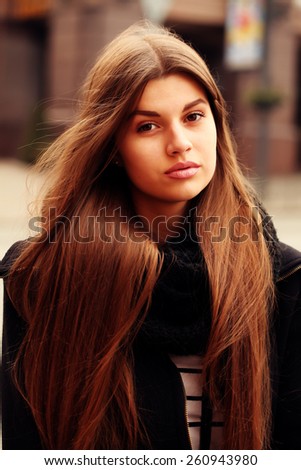 Portrait of beautiful girl outdoors. Young hipster woman in the city traffic